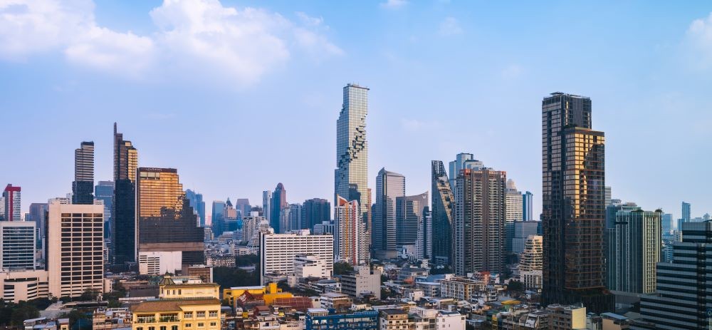 Bangkok skyline in the CBD area, weighing property investment in Thailand vs other countries.